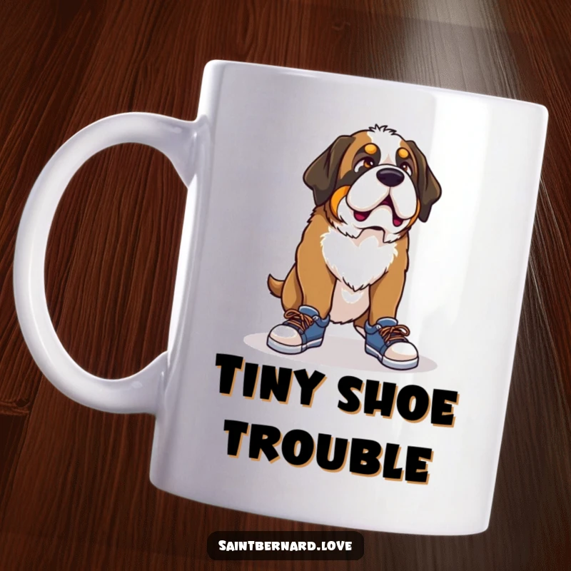 Funny Saint Bernard mug, a dog with a comical expression struggling to put on tiny shoes, highlighting a humorous mismatch.